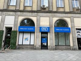 Warsaw, Poland - May 22, 2025 PKN Orlen customer service center exterior view with blue signage and large windows, showcasing urban architecture and inviting atmosphere for clients photo