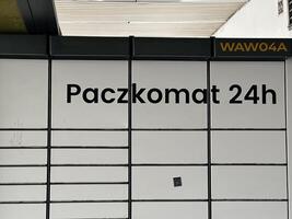 Warsaw, Poland - May 22, 2025 Paczkomat 24h automated parcel locker system in urban setting, showcasing modern delivery solutions with sleek design and functionality photo