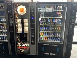 Warsaw, Poland - May 22, 2025 Vending machines displaying a variety of beverages and snacks, featuring Il Caffe Simoka coffee machine, ideal for quick refreshments in busy environments photo
