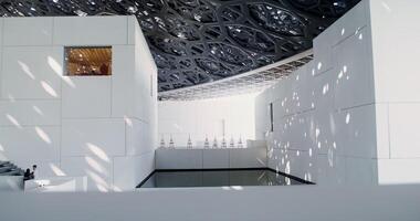 Dubai, UAE, 2025- A white minimalistic museum building with empty easels on display. Abstract structure with an openwork ceiling photo