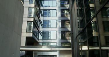 Courtyard of a high rise office building with large windows, located in the office center of the city. in 4k, red komodo photo