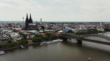 Panoramic drone shot, view of the historical center of Cologne with the Gothic Cologne Cathedral. Bird's eye from the side of the railway bridge on which the train travels. photo
