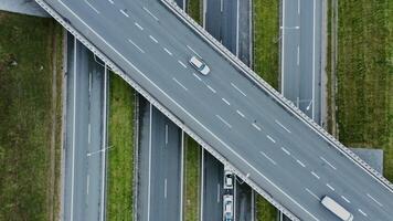 footage from a quadrocopter view of a road bridge over a multi lane road with passing cars. Multi level road, top view, filming from a quadrocopter. photo