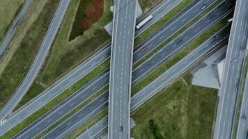 View of the road junction with cars passing along it, shooting from a drone. Multi level road, top view, filming from a quadrocopter. photo