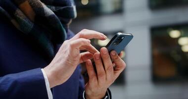 Close up of male hands typing on a mobile phone, viewed from below. No face, unrecognizable person. in 4k, red komodo photo