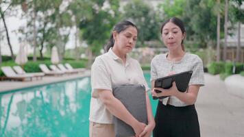 An estate agent demonstrates the pool's quality in a visual inspection to a potential client. video