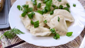 Appetizing dumplings with potatoes and onions on a rustic table video