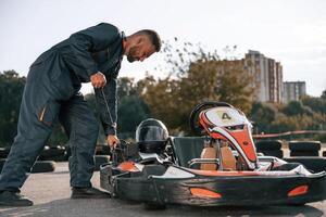 Starting,, the vehicle. Man is outdoors, kart racing conception photo