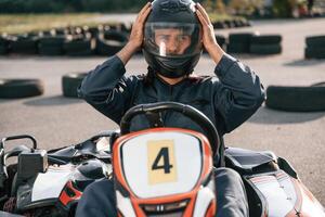 Front view, driving., Man is outdoors, kart racing conception photo