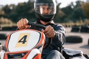 Front view, driving., Man is outdoors,,, kart,, racing conception photo