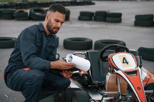 Man is, outdoors, kart racing conception. photo