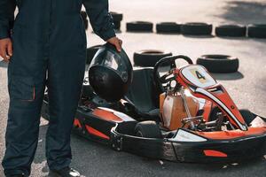 Close ,up ,view, holding ,safety helmet. Man is outdoors, kart racing conception photo