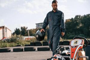 Walking, by, the ,vehicle.,, Man is outdoors, kart racing conception photo
