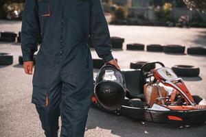 Close up view, holding, safety,, helmet. Man is outdoors, kart racing conception photo