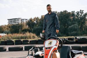 Walking by, the vehicle. Man is outdoors, kart racing conception photo
