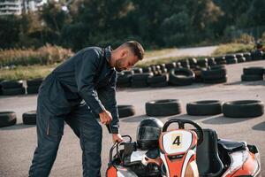 Starting the vehicle. .Man is outdoors, kart racing conception photo