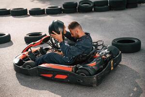 Wearing the ,safety helmet. Man is outdoors, kart racing conception photo