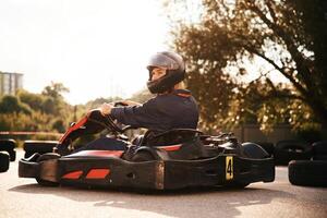 Trees,, and sunlight. Man is outdoors, kart racing conception photo