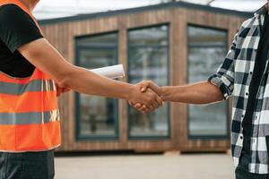 Agreement,, handshake. Two workers ,are,, in the industrial wooden warehouse photo