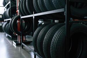 New tires are placed on, the ,storage, rack i,n the car workshop photo