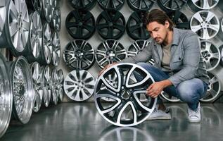 Big choice. Man is in ,,,the tire fitting car service photo