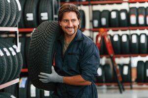 Cheerful, smiling...., Man is in the tire fitting car service photo