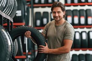 Customer is choosing the tire. Man is in ,,,,the tire fitting car service photo