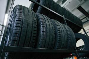 In the ,right ,order... New tires are placed on the storage rack in the car workshop photo