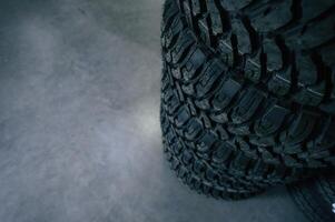 Particle close up view. New tires are ,,placed on the storage rack in the car workshop photo