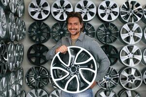 Disk in ,hands.,,, Man is in the tire fitting car service photo