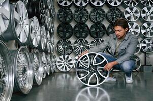 Big, choice.... Man is in the tire fitting car service photo