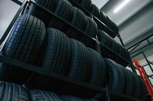 On the shelves... New tires are placed ,on the storage rack in the car workshop photo
