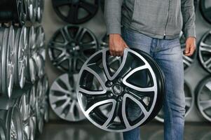 Disk ,in, hands... Man is in the tire fitting car service photo