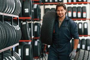 Moving the tire. Man ,,is in, the ,tire fitting car service photo