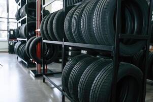 New tires are placed on the storage ,,rack in the car workshop photo