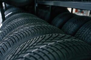 In, the ,right order. New tires are placed on the storage rack in the car workshop photo