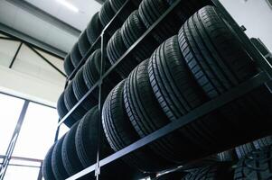 On the shelves., New tires are ,,placed on the storage rack in the car workshop photo
