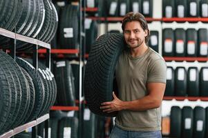 Customer is choosing the tire. Man, is ,in ,the, tire fitting car service photo