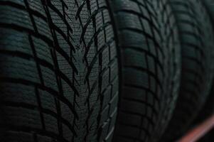 Particle, close, up view. New tires are placed on the storage rack in the car workshop photo