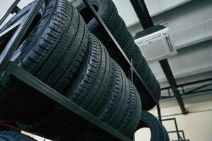 On the shelves. New tires, are placed on the storage rack in the car workshop photo