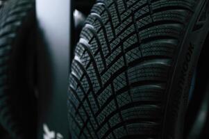 Particle close up view. New tires,, are placed on the storage rack in the car workshop photo