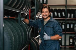 Cheerful, smiling... Man is in the tire fitting car service photo