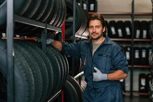 In professional, uniform. Man is in the tire fitting car service photo