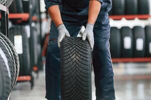 Detailed close, up, view, moving the wheel. Man is in the tire fitting car service photo
