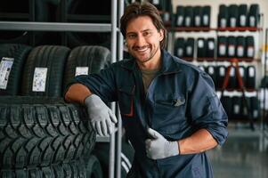 Positive ,facial expression. Man ,is in the tire fitting car service photo