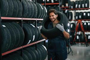 Positive,, facial expression. Man is in the tire fitting car service photo