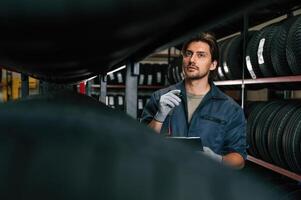 Collecting information, counting, notepad.. Man is in the tire fitting car service photo