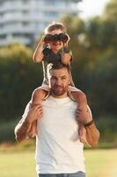 Looking through ,,,the binocular. Father and son are together on the field photo