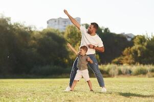 Flying hands gesture,. Father and son are together on the field photo