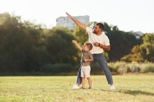 Flying hands, gesture. Father, and son are together on the field photo